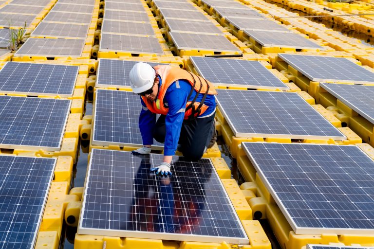 Renewable Energy Eco Technology Electric Power. Floating solar panels on lake.