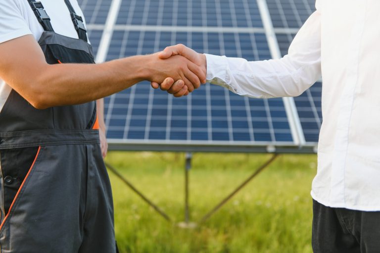 Shaking hands of engineers after the conclusion of the agreement in the renewable energy