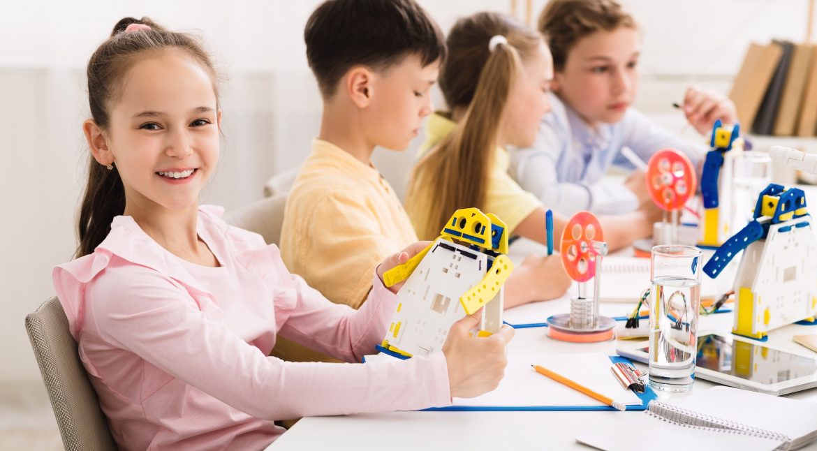 Stem education. Girl creating robot at lab